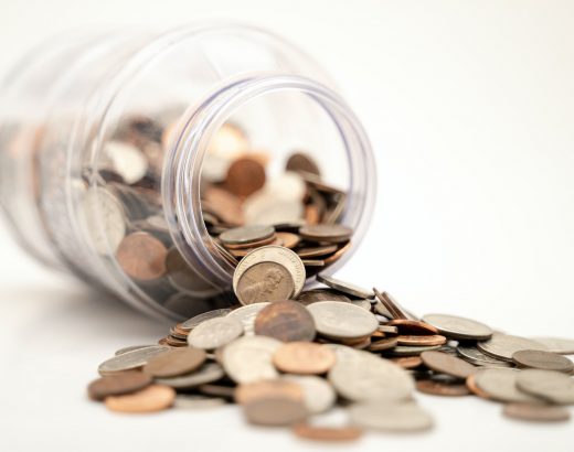 Coins and a fallen jar illustrate how you can make an extra income