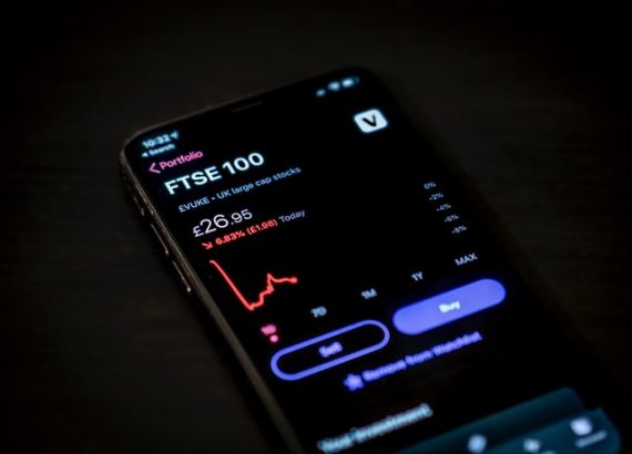 A phone showing stock and cryptocurrency trading
